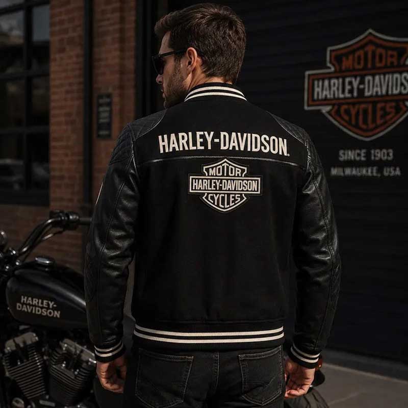 Men's black varsity bomber jacket showing its wool-style body and leather sleeves.