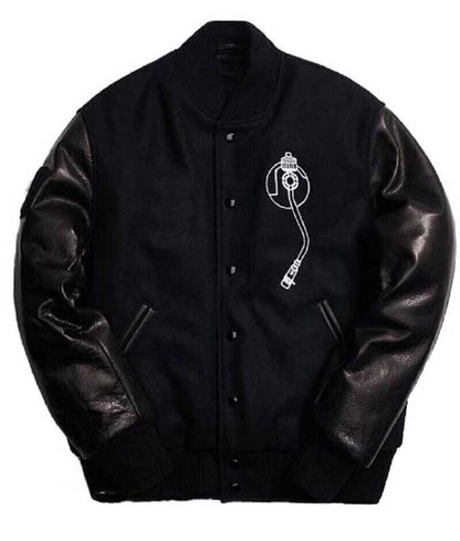 Front view of a black Def Jam varsity bomber jacket with embroidered patches and snap buttons.