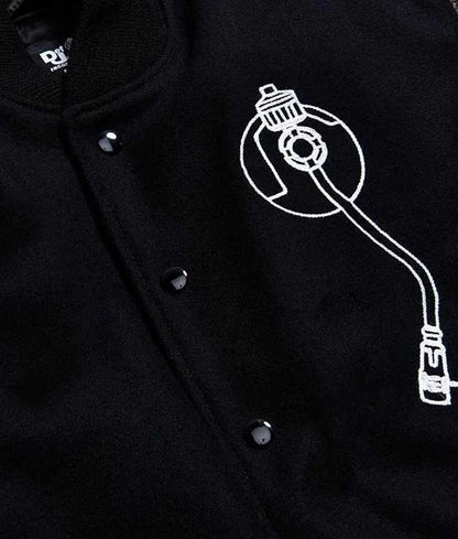 Close-up of the embroidered front patches on the Def Jam-inspired varsity jacket.