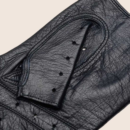 Close-up of a black leather glove with stitching details