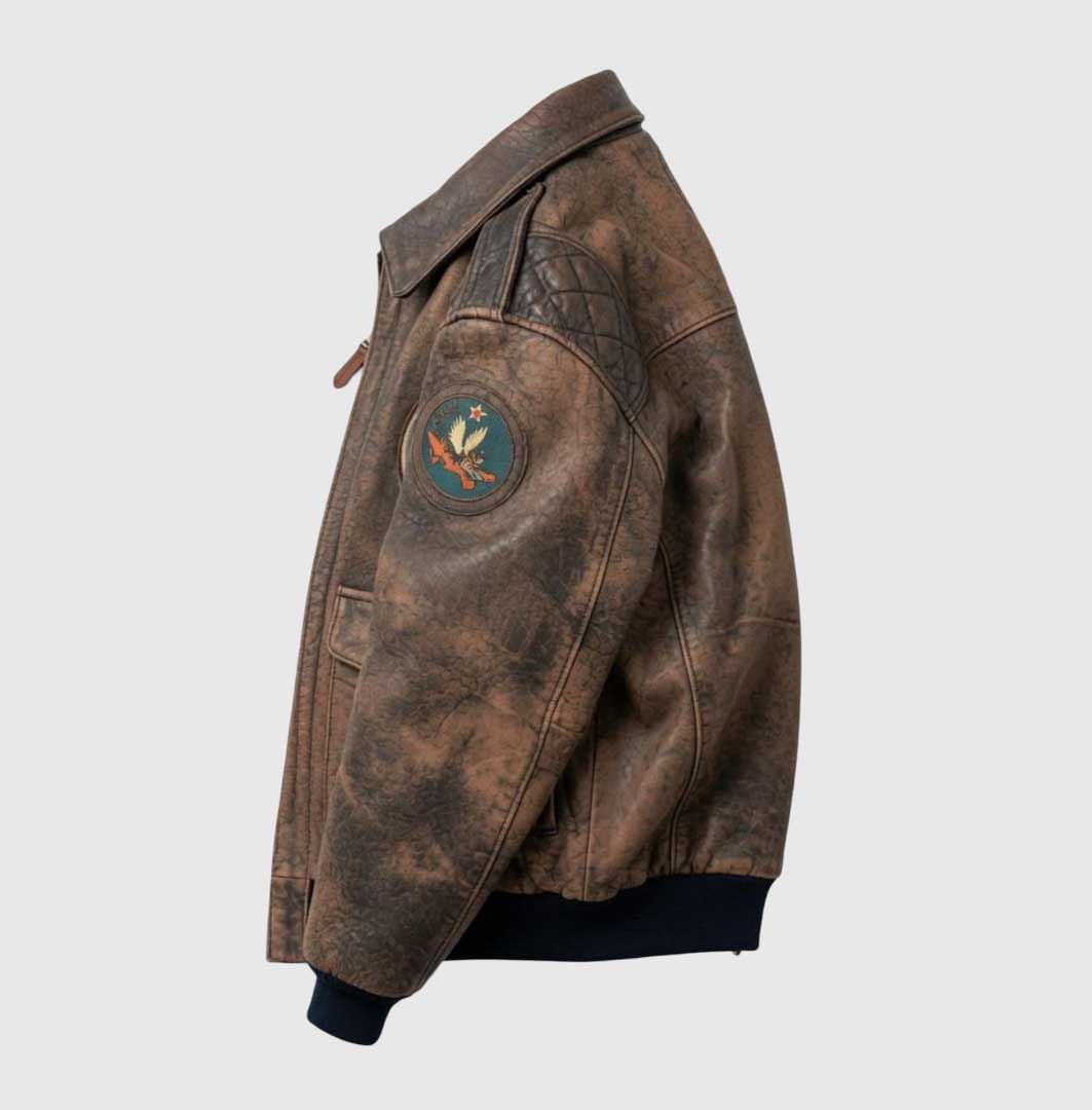 Men's brown leather bomber with long sleeves and ribbed cuffs.